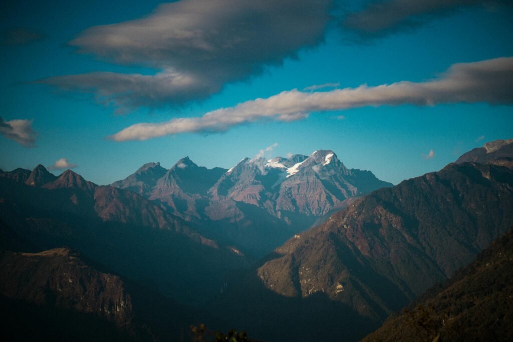 Experience the majestic beauty of Tawang's mountain range with snow-capped peaks and dramatic skies.